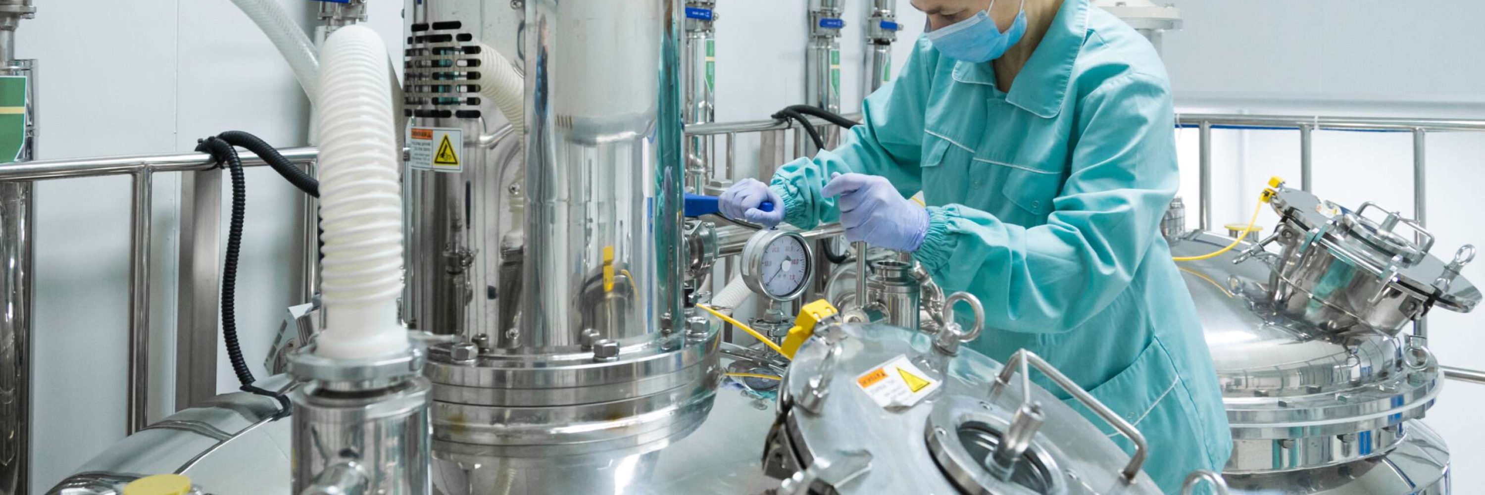 Pharmaceutical technician in sterile environment at pharmacy industry